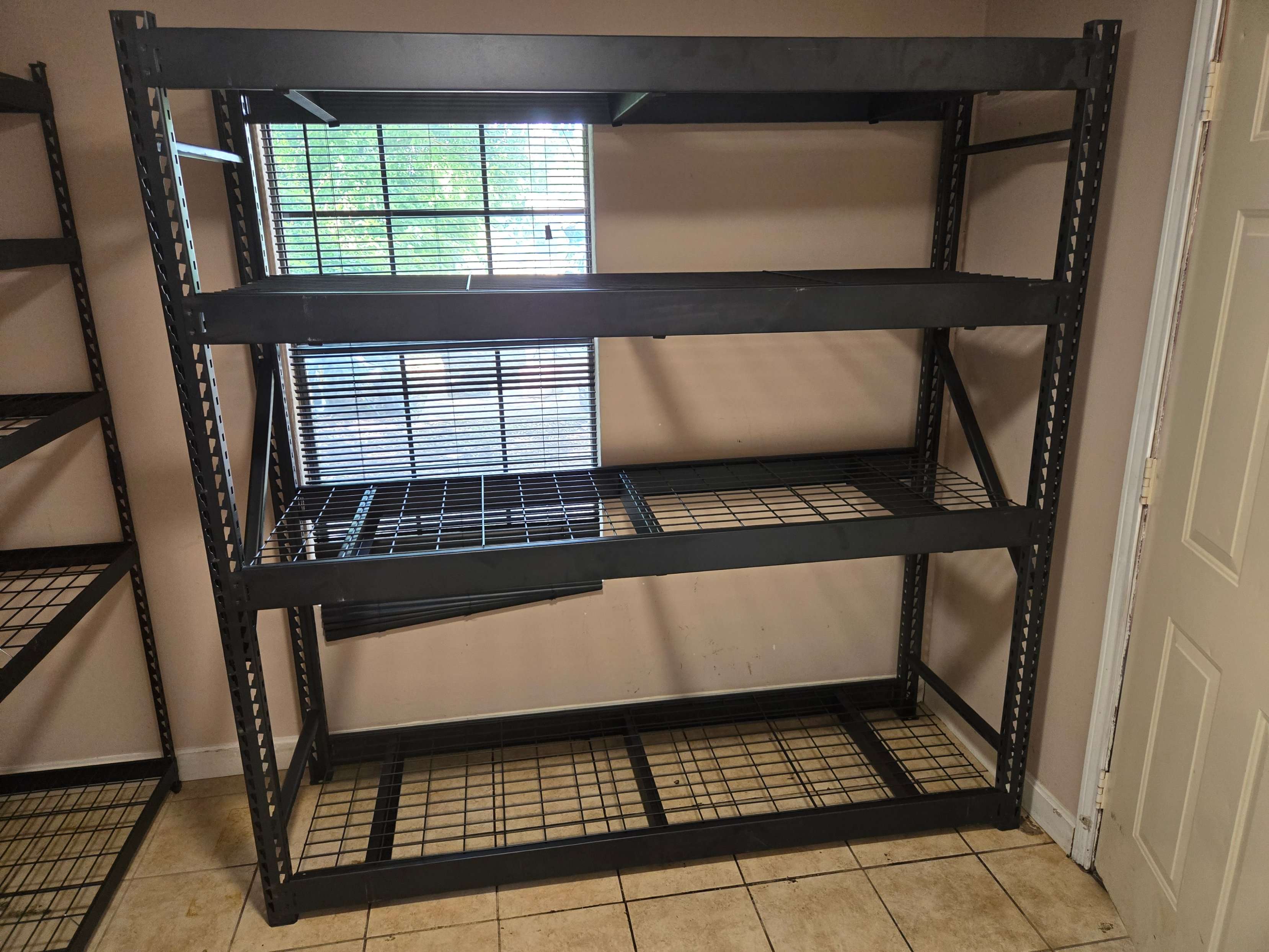 Husky industrial steel shelving unit assembly by Mount & Fix, next to a finished unit