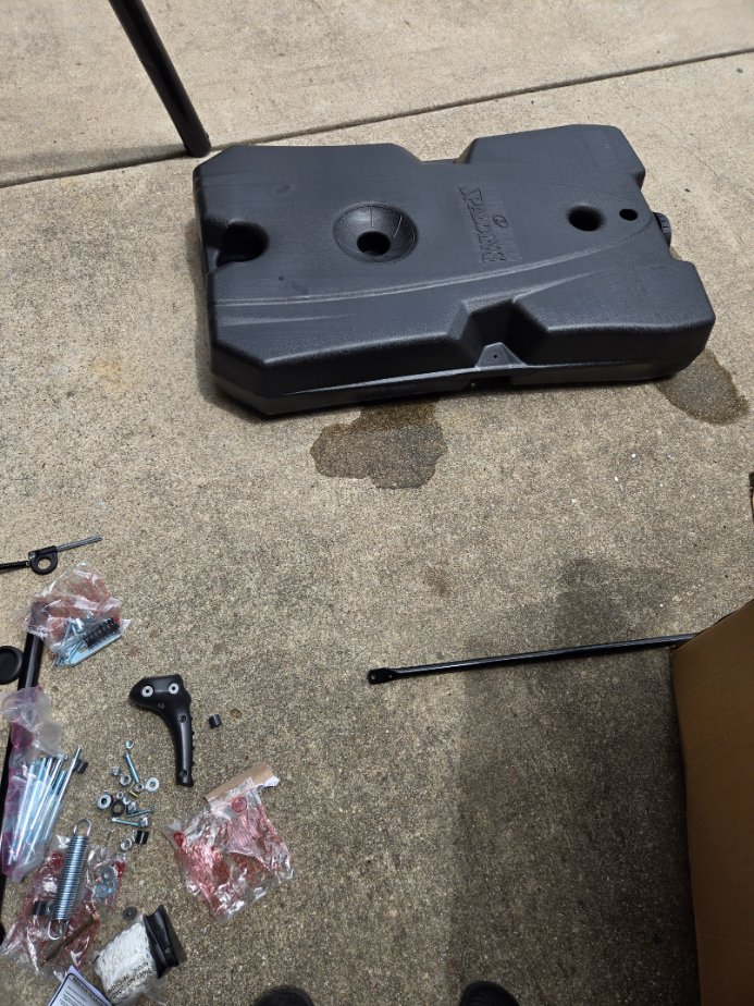 Box containing a portable basketball hoop, ready for assembly by Mount & Fix