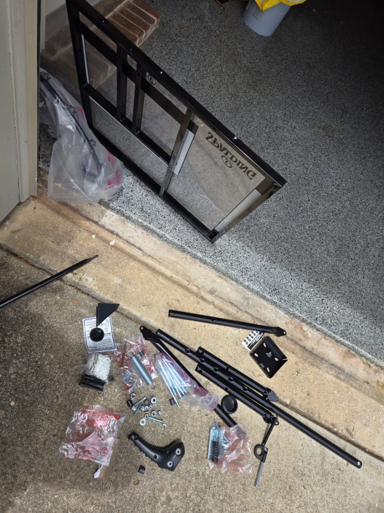 Parts of a portable basketball hoop laid out for assembly by Mount & Fix Dallas