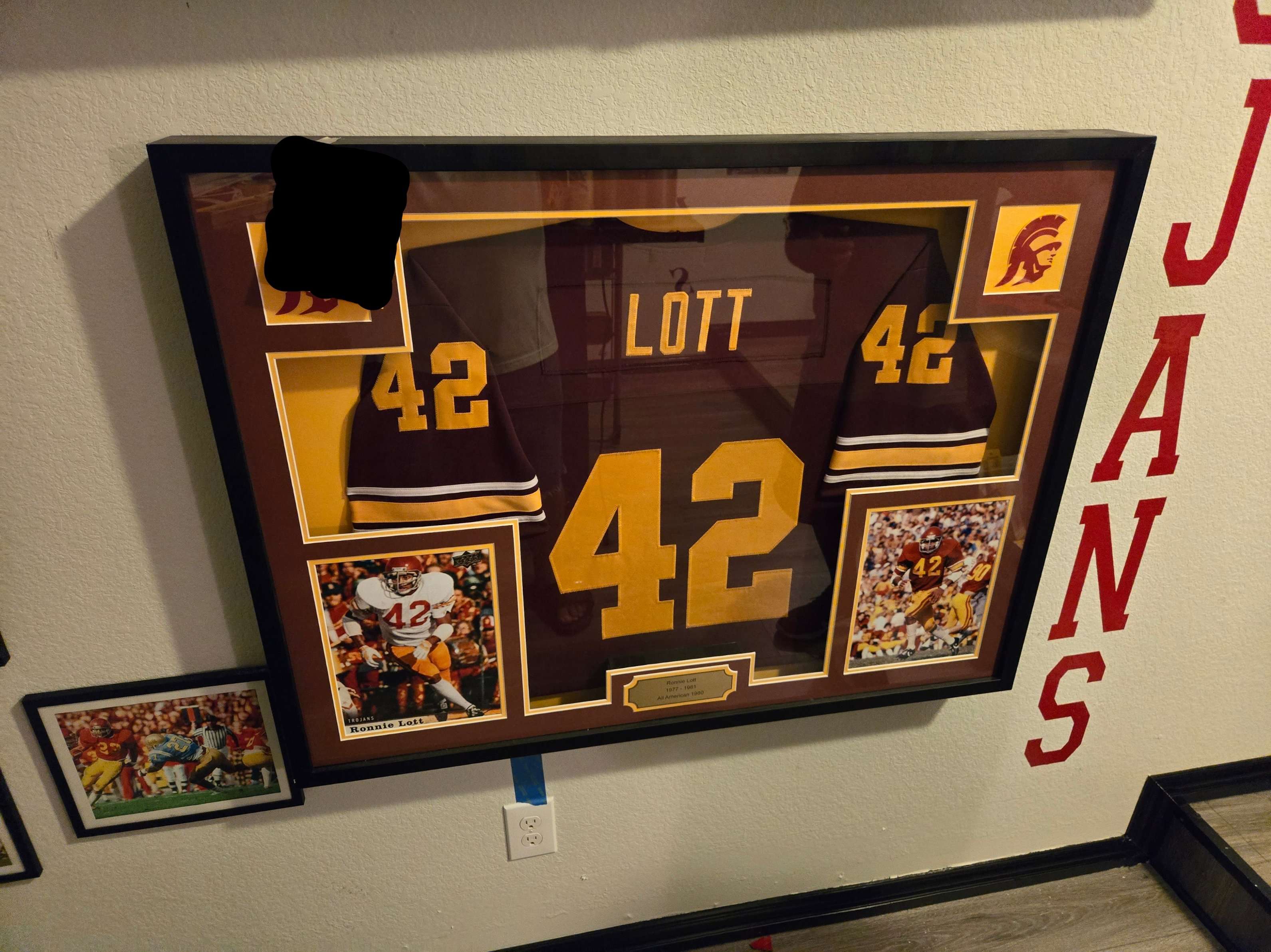 A framed sports jersey expertly hung on a wall by Mount & Fix in DFW